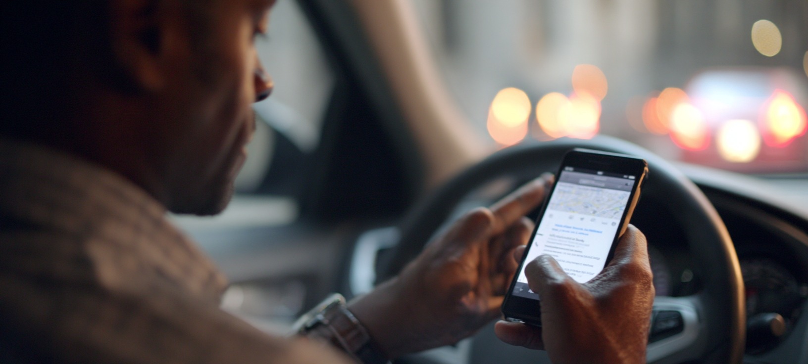 a rideshare driver checks his app for work