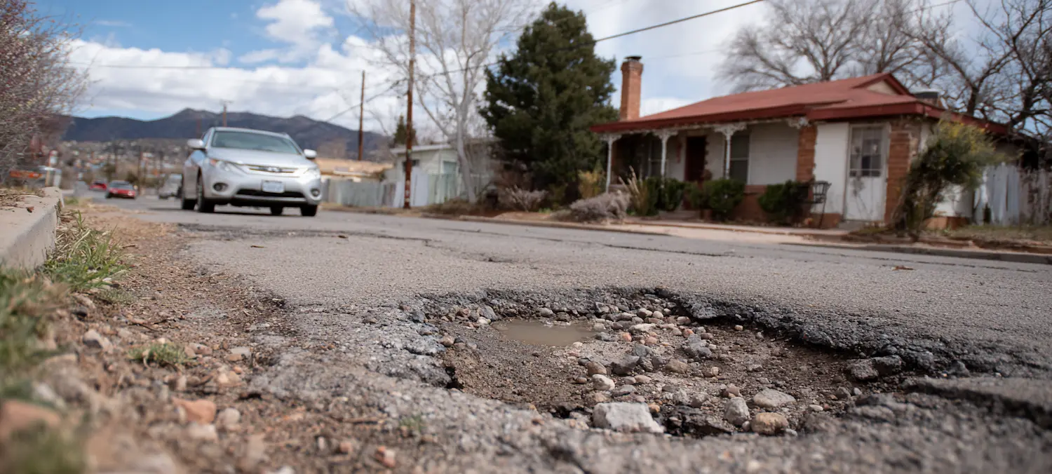 a car is about to hit a pothole and the city can be sued