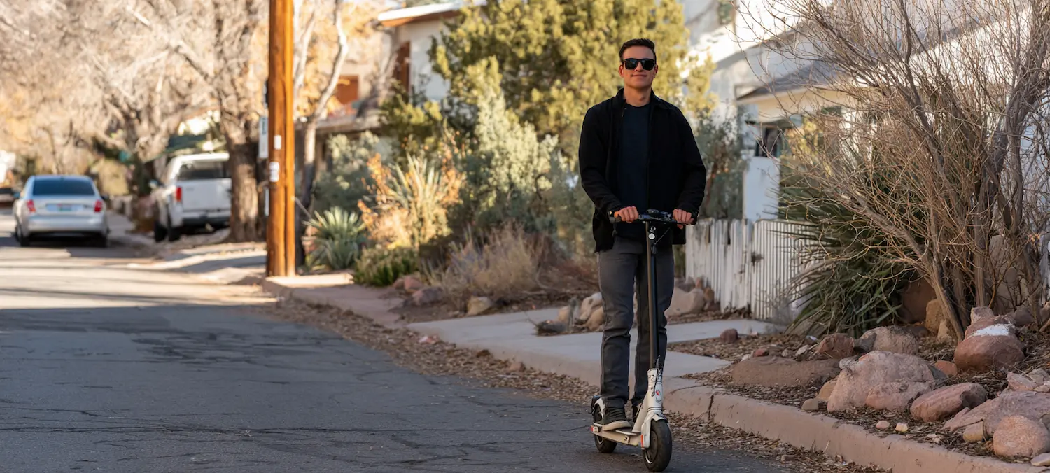 a handsome man on an e-scooter in new mexico