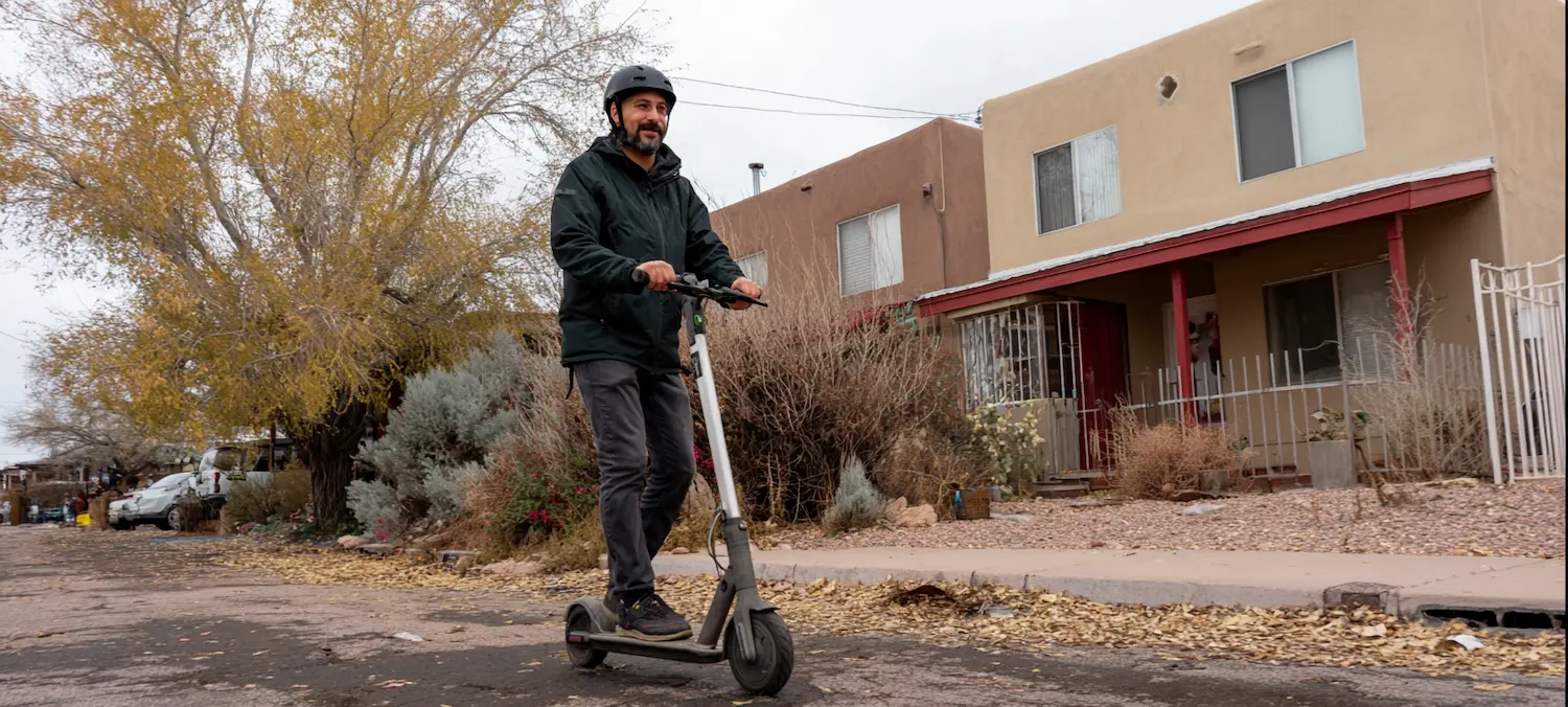 an e-scooter rider in a new mexico suburb avoids getting hit by a car