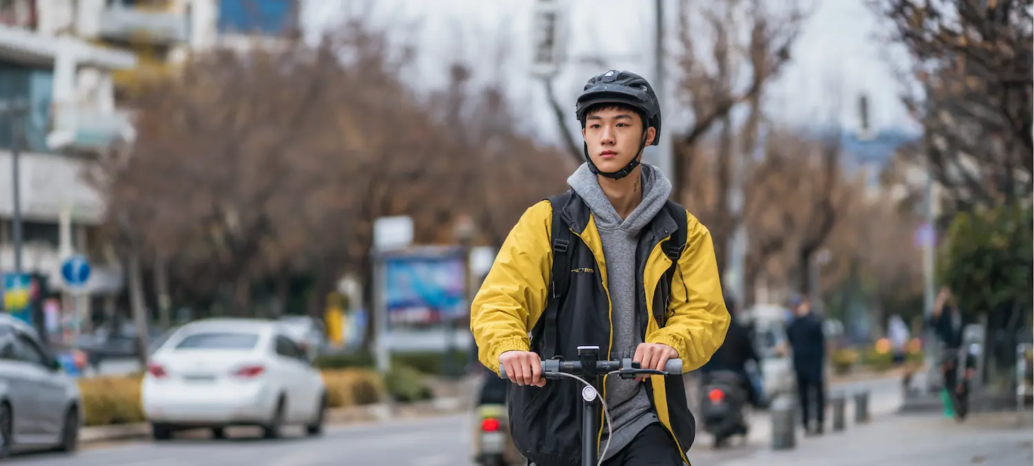 e-scooter rider is worried about getting hit by a car
